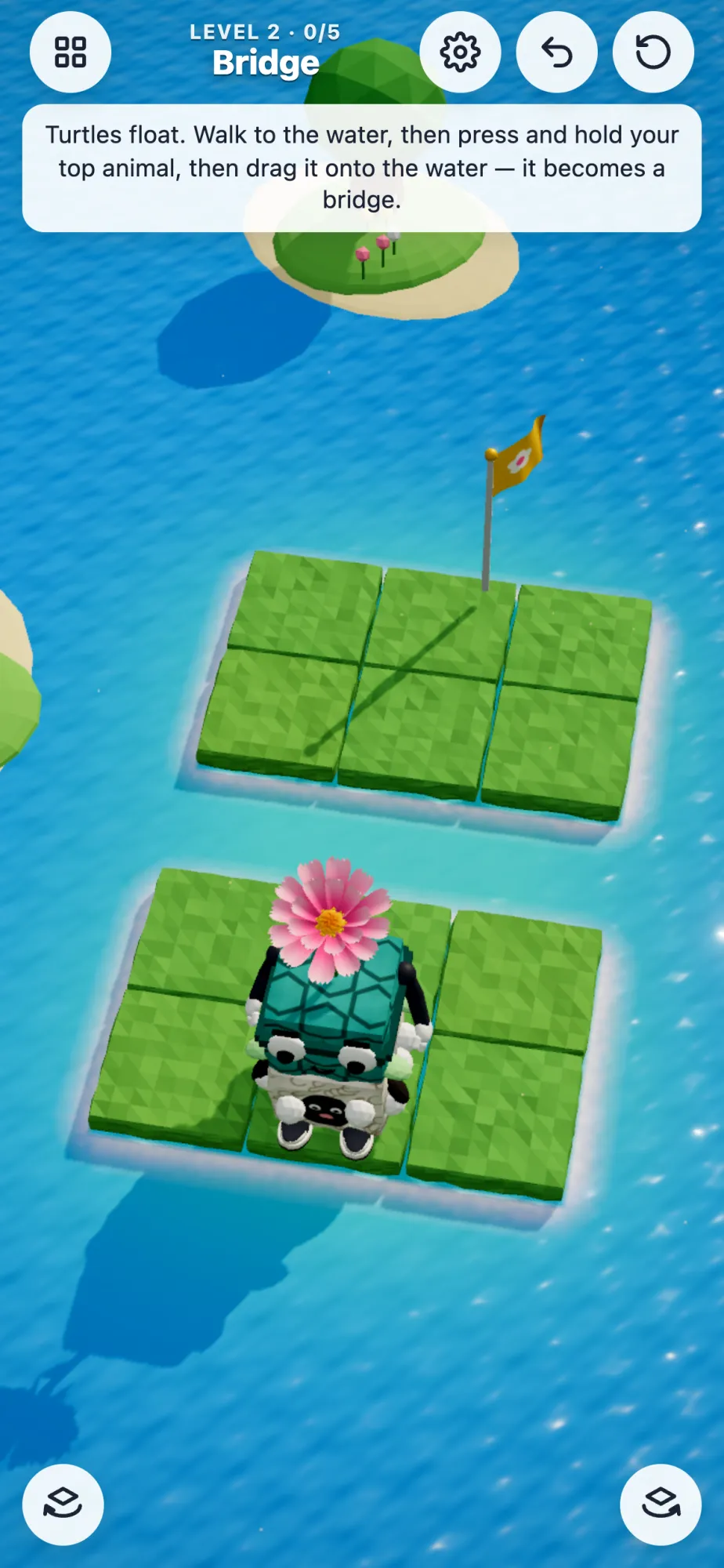 A turtle stack on a small island beside the water, the flag on the next island