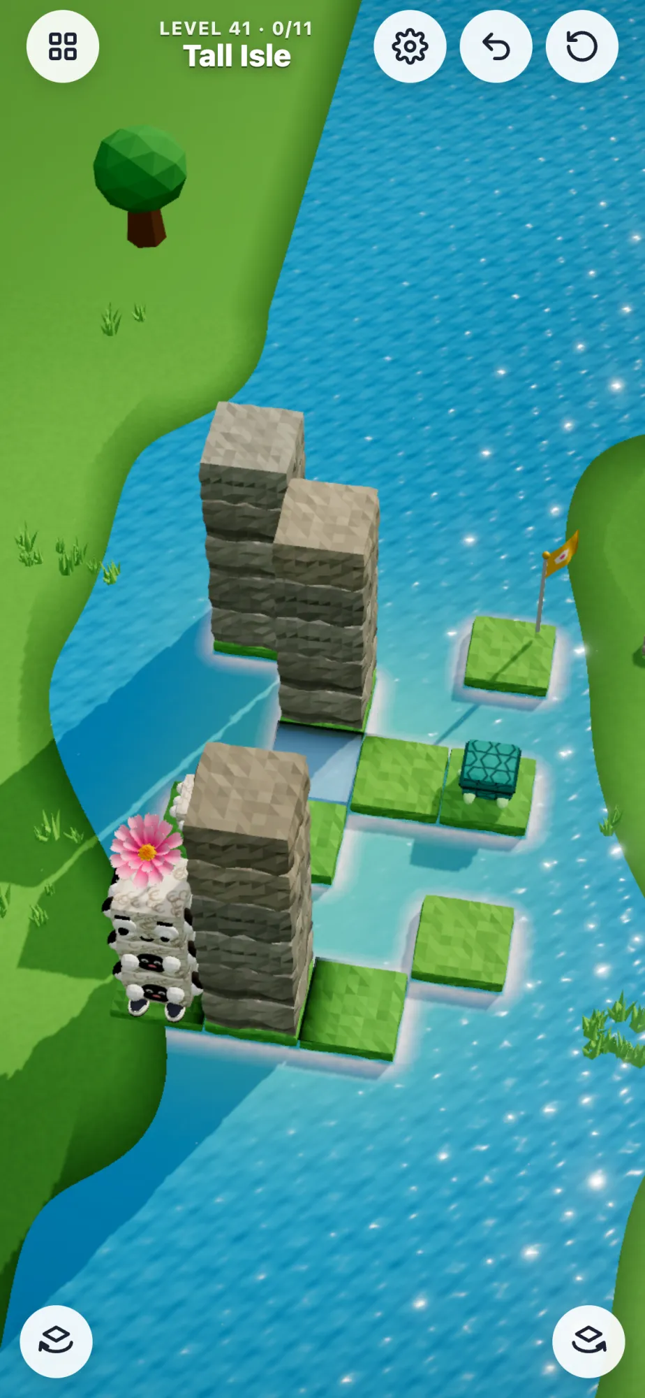 A tall stack of animals beside stone towers on an island